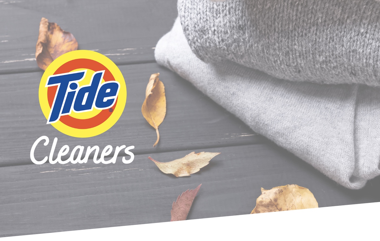 Tide cleaners logo makes you fall in love with doing laundry again on a wooden floor.