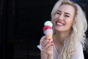 A young woman holding an ice cream cone is ready for some summertime fun.