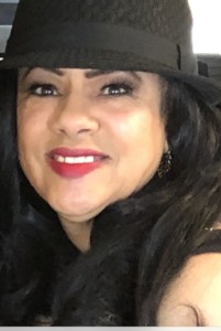 Resident Spotlight on Sonya C, a woman wearing a black hat and lipstick on the 6th floor.