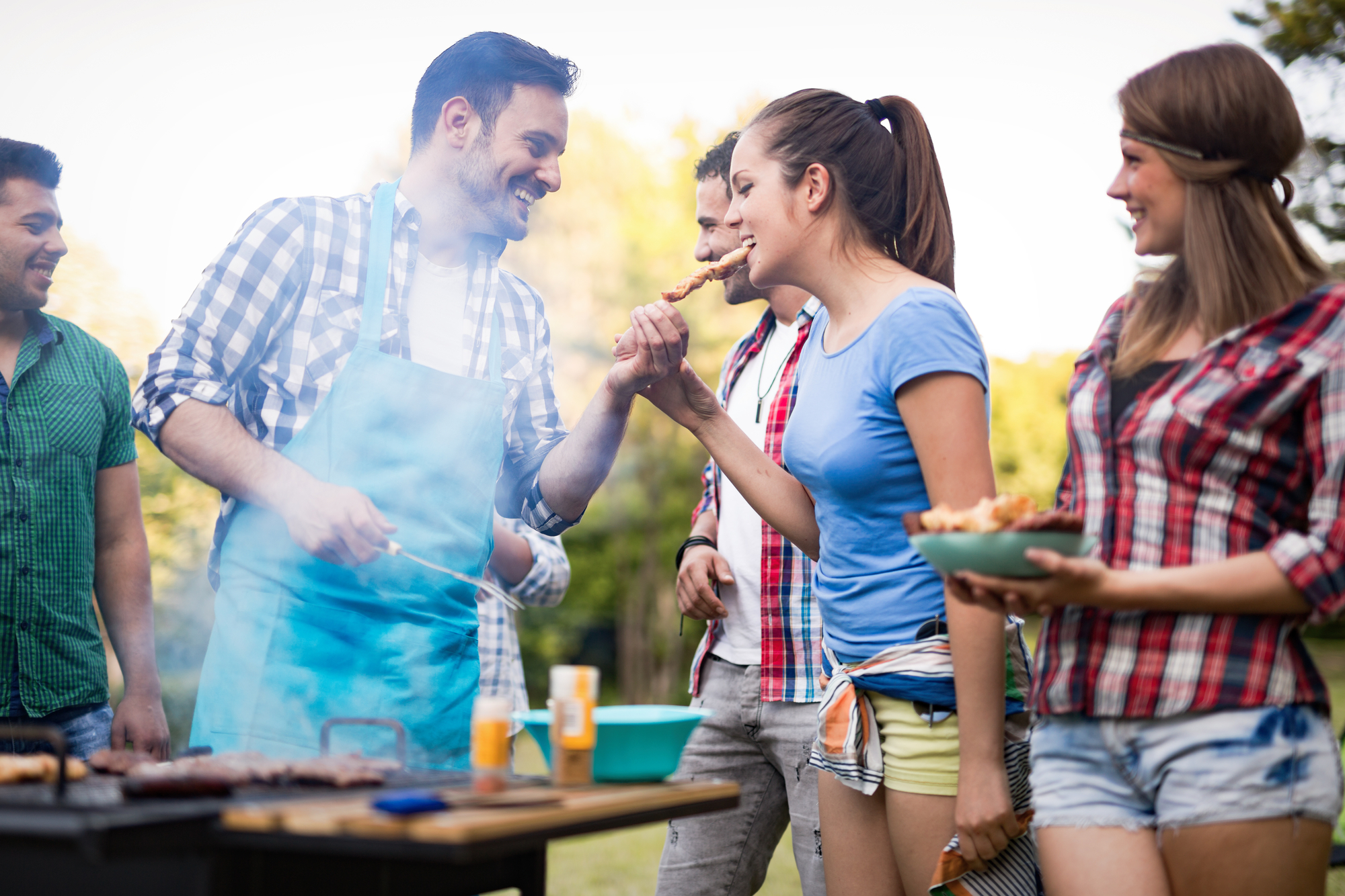 Friends having a barbecue party in nature